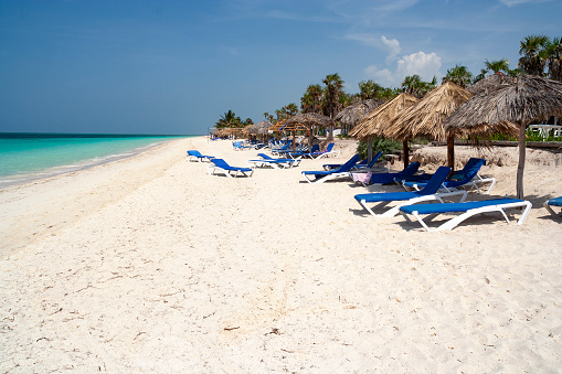 A serene image of a beach in Cayo Coco, capturing the pristine white sands and crystal-clear turquoise waters of this idyllic tropical paradise. The scene embodies the tranquil beauty of this Cuban island, known for its unspoiled beaches and serene natural landscapes.