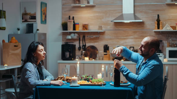 istock Man opening a bottle of wine 1910685077