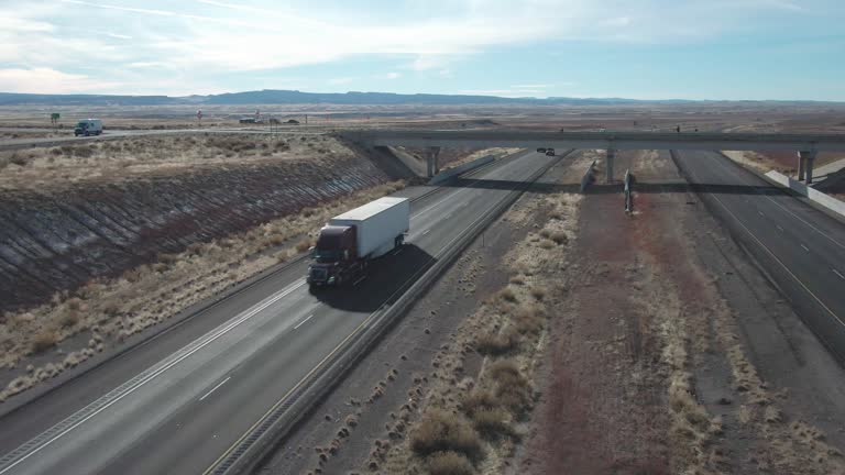 A Drone Shot of a Semi Truck on I-70 in Utah Traveling East on a Sunny Winter Day