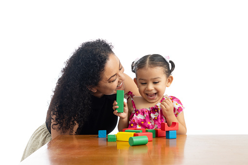 Little girl excited and laughing while playing with her mother.