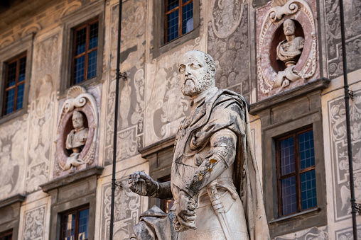 Rich ornate facade of the Palazzo della Carovana in the center of Pisa, Italy