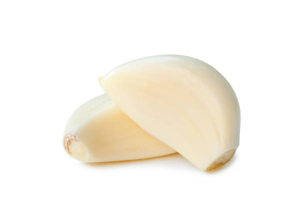 istock Peeled garlic cloves in stack isolated on white background with clipping path 1910750359