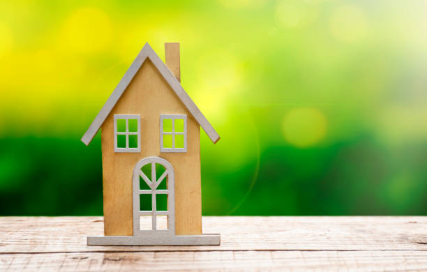 istock Wooden house model on wooden table 1910777612