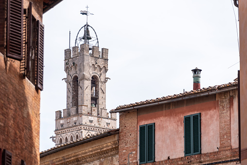 Tower of the iconic Palazzo Pubblico at the Piazza del Campo in downtown Siena, Italy