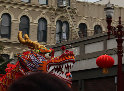 A dancing dragon puppet parades through Chinatown in Portland, Oregon as part of the Lunar New Year festivities, recreating the creation story.