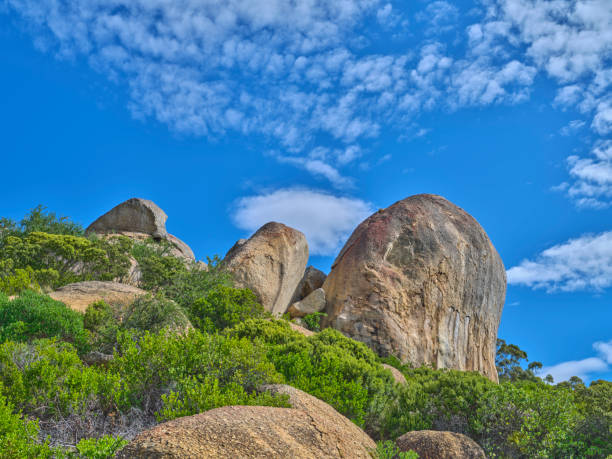 boulders and wilderness - and blue sky with clouds - straggling стоковые фото и изображения