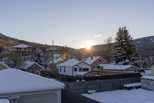 Sunrise over town and mountains in winter