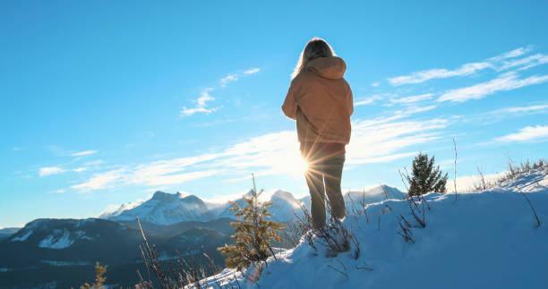 istock Young woman explores snowy hillside 1910804050