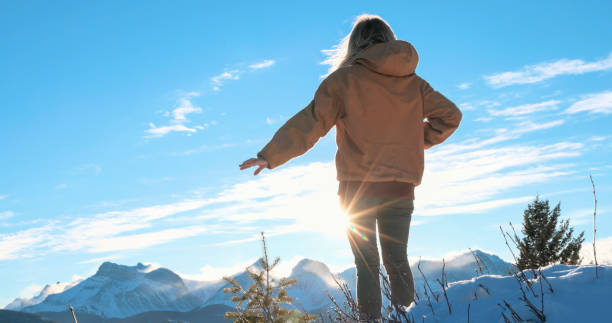 istock Young woman explores snowy hillside 1910804052