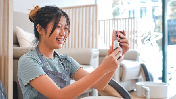 istock Young Asian woman video conferencing 1910834184