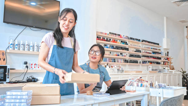 istock Young Asian entrepreneur packing orders 1910836255