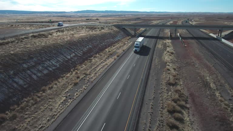 A Drone Shot of a White Semi Truck on I-70 in Utah Traveling East on a Sunny Winter Day