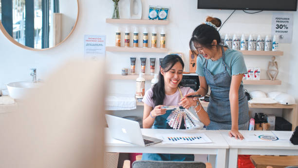 istock Young Asian Entrepreneur looking at phone smiling 1910842484