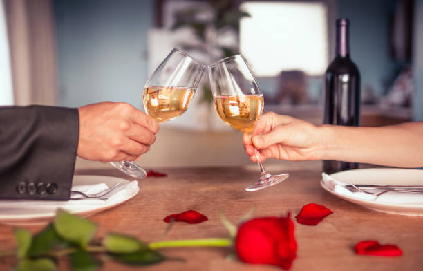 istock Couple having romantic dinner. Couple having a celebratory toast. 1910859477