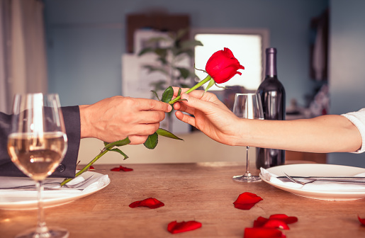 Men giving rose to his women.