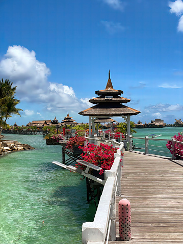 Mabul Island, Sabah, Malaysia - Feb 28 2023: Discover serenity at Mabul Island Resort, Malaysia. Crystal-clear waters surround overwater chalets on this beautiful tropical day. Paradise found.