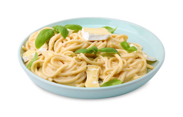 istock Delicious pasta with brie cheese and basil leaves isolated on white 1910864166