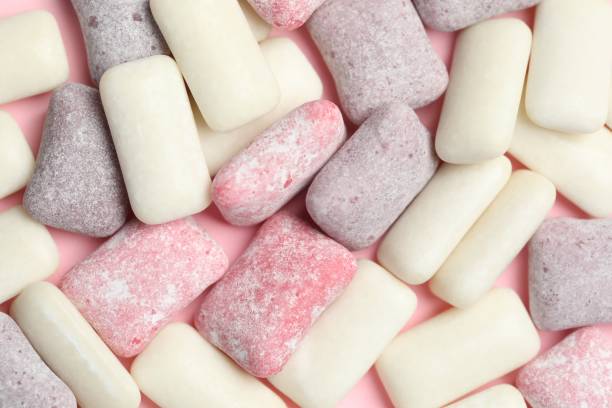 istock Different tasty colorful bubble gums on pink background, flat lay 1910868266