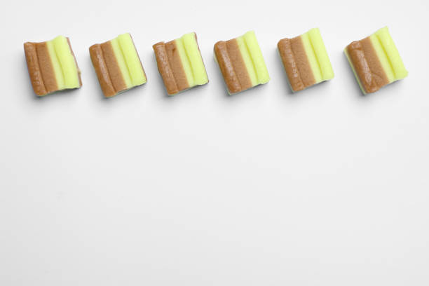 Tasty colorful bubble gums on white background, flat lay. Space for text