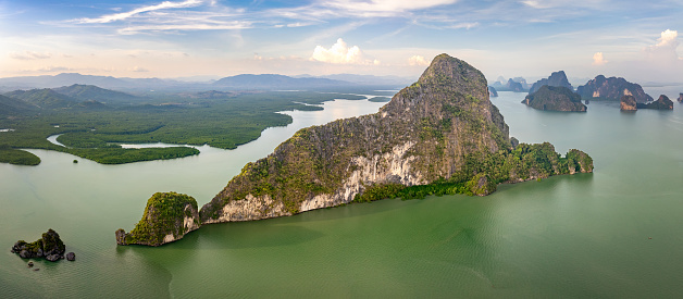 Phang Nga Bay Thailand Aerial Panorama. Phang Nga Bay Islands and Islets scenic Drone View. Famous Thai Islands and small Islets in the Andaman Sea under blue summer sky. Drone Point of View over the coastal Thai Andaman Sea Islands. Phang Nga Bay, Phuket, Thailand, Southeast Asia, Asia.