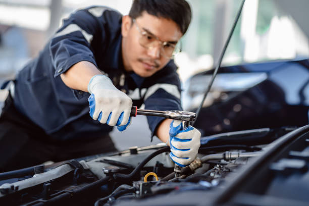 istock Auto mechanic repairman using a socket wrench working engine repair in the garage, changing spare parts, checking the mileage of the car, maintaining service automobile car 1910907922