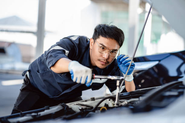 istock Auto mechanic repairman using a socket wrench working engine repair in the garage, changing spare parts, checking the mileage of the car, maintaining service automobile car 1910907923