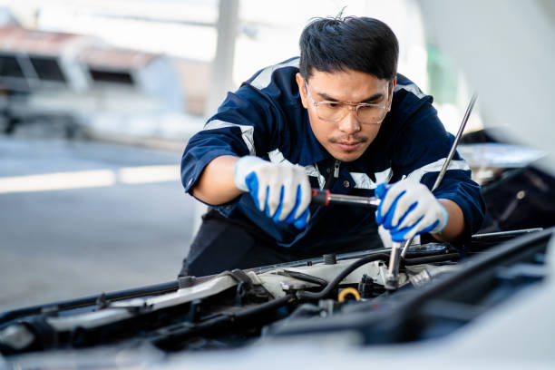 istock Auto mechanic repairman using a socket wrench working engine repair in the garage, changing spare parts, checking the mileage of the car, maintaining service automobile car 1910913658