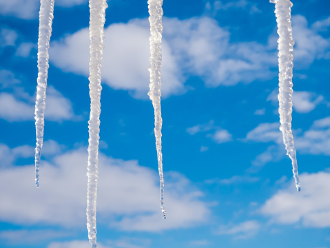 Icicles on the blue sky background