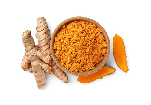 Bowl with aromatic turmeric powder and raw roots isolated on white, top view