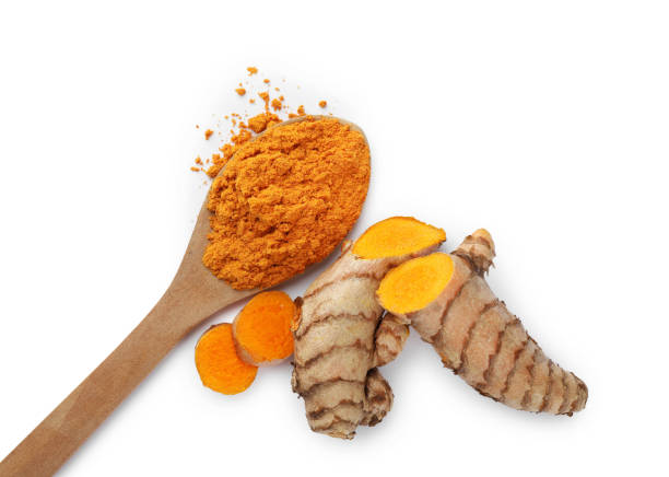 istock Spoon with aromatic turmeric powder and raw roots isolated on white, top view 1910941249