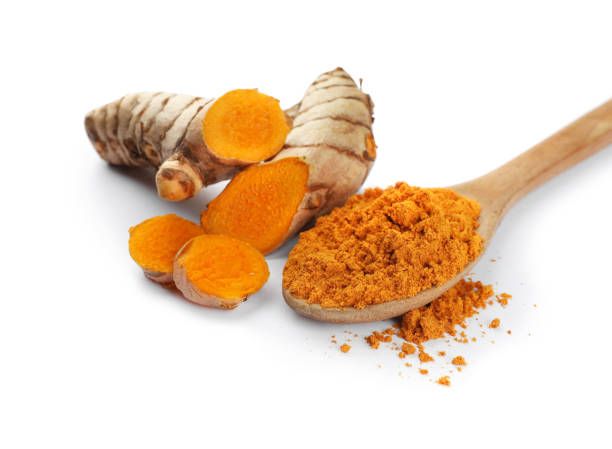 istock Spoon with aromatic turmeric powder and raw roots isolated on white 1910941762
