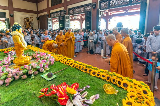 Ho Chi Minh City, Vietnam - May 19th, 2019: View inside the temple with monks and Buddhists preparing for the Buddha birthday celebration at pagoda in Ho Chi Minh City, Vietnam