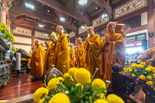 Ho Chi Minh City, Vietnam - May 19th, 2019: Monks are chanting prayers for peace during Buddha birthday celebration held in evening at an ancient temple in Ho Chi Minh City, Vietnam