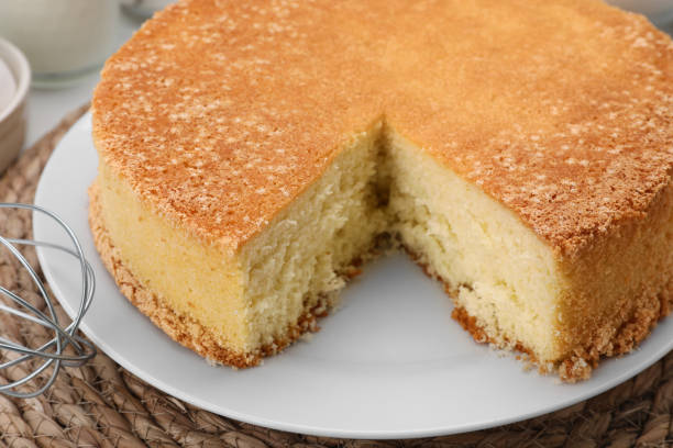 istock Cut tasty sponge cake on table, closeup 1910965322