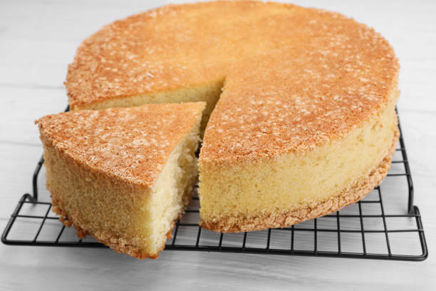 istock Tasty sponge cake on white wooden table, closeup 1910966357