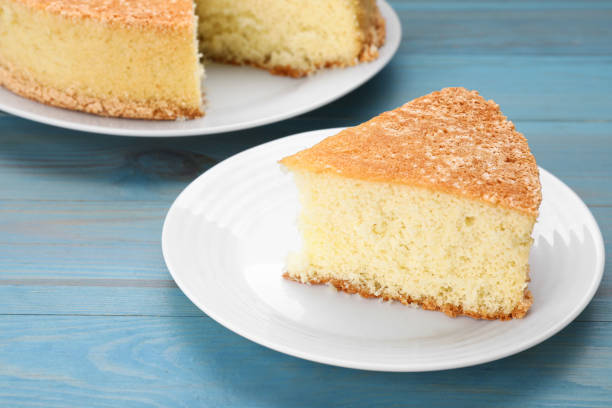 istock Tasty sponge cake on light blue wooden table 1910966877
