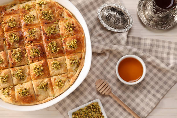 istock Delicious sweet baklava served on white table, flat lay 1910969451