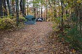 Overland camping site in woods during autumn