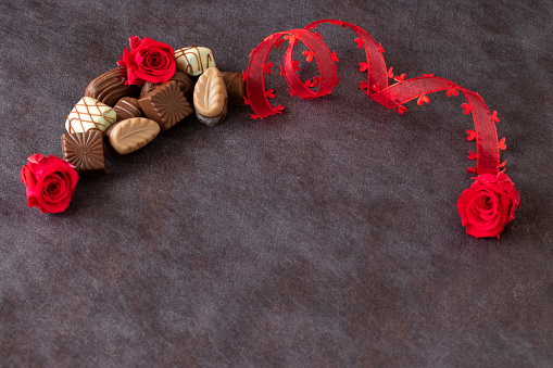 Valentin's images with chocolate and red roses and heart ribbon.