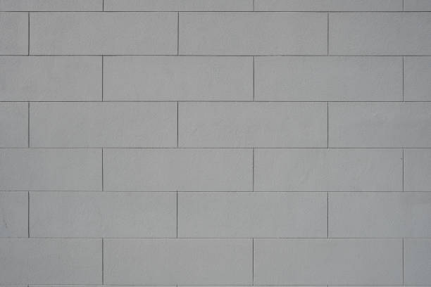 istock Part of a clean painted gray concrete block wall 1911016227