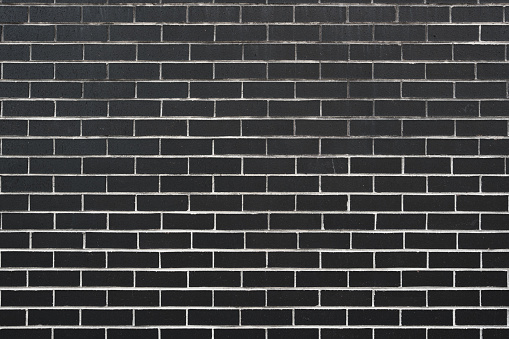 Section of a clean black brick wall.