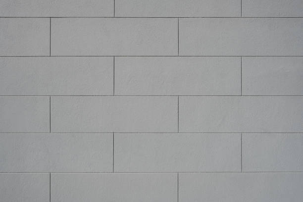 istock Part of a clean painted gray concrete block wall 1911017786