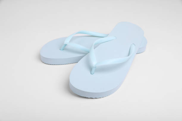 istock Pair of stylish flip flops on white background 1911021509