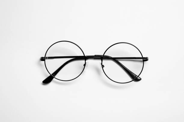 istock Stylish pair of glasses with black frame on white background, top view 1911033165