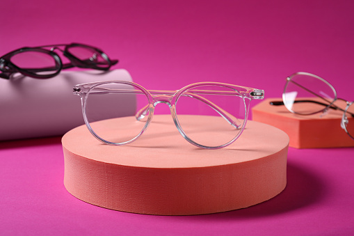 Stylish presentation of different glasses on pink background, closeup