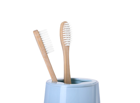 Bamboo toothbrushes in holder isolated on white