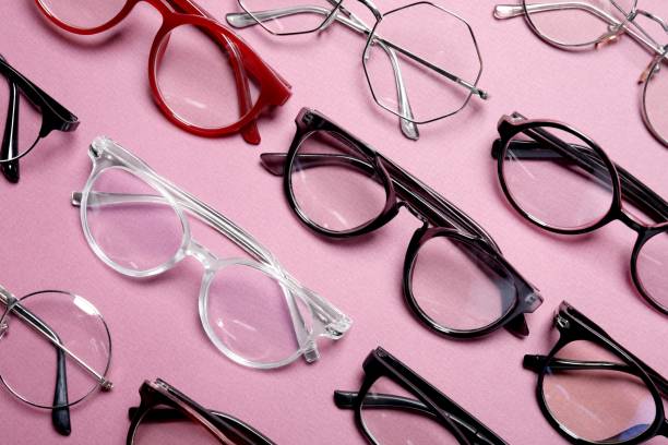 istock Different stylish glasses on pink background, flat lay 1911038443