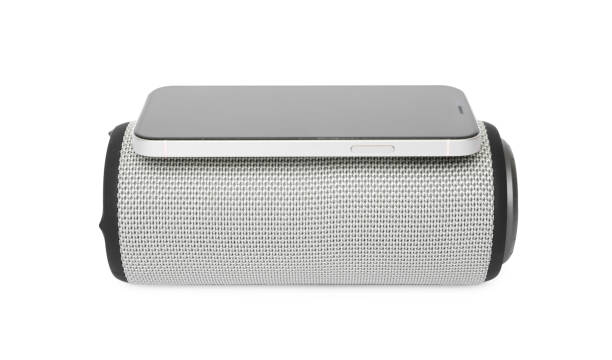 istock Portable bluetooth speaker and smartphone isolated on white. Audio equipment 1911043637
