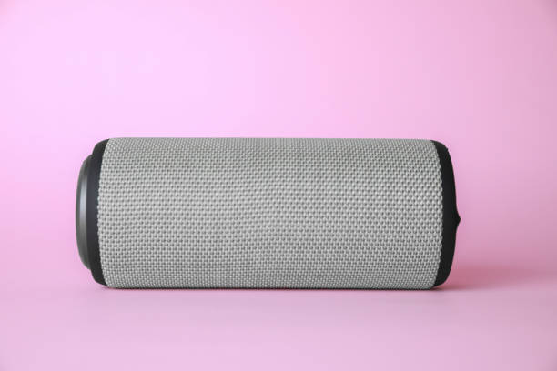 istock One portable bluetooth speaker on pink background. Audio equipment 1911044715