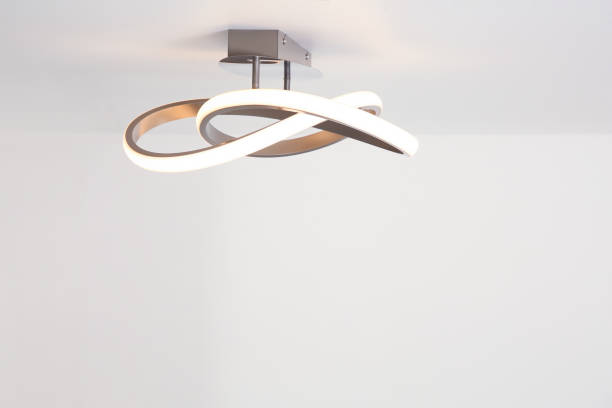 istock White ceiling with stylish lamp in room. Space for text 1911045236